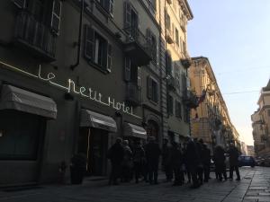 a group of people walking down a street at Le Petit Hotel in Turin