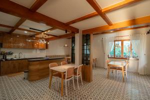 a kitchen and dining room with a table and chairs at Gió Villa in Ấp Sơn Hải
