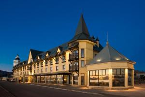 a large building with a clock on the front of it at Hotel Costaustralis in Puerto Natales