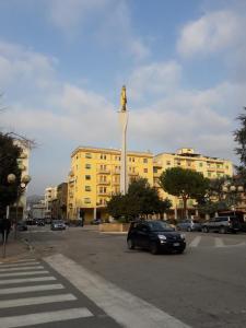 a car parked in front of a building with a statue at Stella in Ascoli Piceno