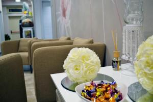 a table with a plate of food and flowers on it at Hotel Sant'Anna in Turin