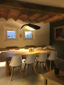 a dining room with a large wooden table and chairs at De Gouden Klokke in Avelgem