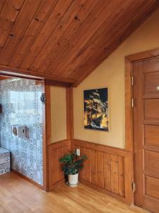 a room with a wooden ceiling and a door at 버킷 제주 - Bucket Jeju in Seogwipo