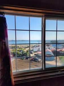 a window with a view of a construction site at 버킷 제주 - Bucket Jeju in Seogwipo