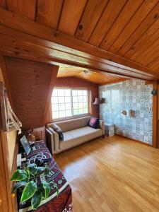 a large living room with a couch and a window at 버킷 제주 - Bucket Jeju in Seogwipo