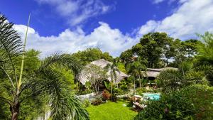 a garden with a pool and a gazebo at Mantra Wellness Center in Uluwatu