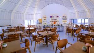 a restaurant with tables and chairs in a tent at Tegri Gobi Resort 