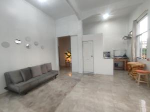 a living room with a couch and a table at Pachamic House in Guayaquil