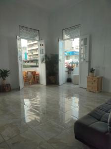 a living room with a couch in the middle of a room at Pachamic House in Guayaquil