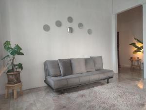 a grey couch in a living room with a rug at Pachamic House in Guayaquil
