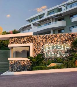 a building with a sign on the side of it at Luxury Sea View Apartment Spa Pool Gym La Cala de mijas in Málaga