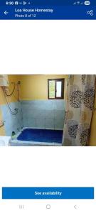 a bathroom with a shower with a shower curtain at sandbar Homestay in Lautoka