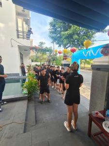 a group of people walking down a street at Horizon 2 villa in Hoi An +136 photos