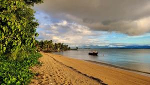 a boat in the water on a beach at sandbar Homestay in Lautoka