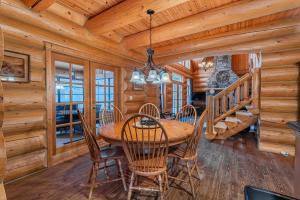 a dining room with a wooden table and chairs at Fiddler Lake Resort - Bear 22 in Mille-Isles