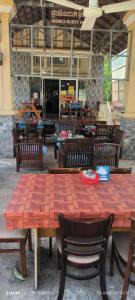 a wooden table and chairs in a restaurant at Monica Guesthouse in Kampot