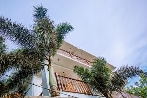 a building with palm trees in front of it at King Palace Mirissa in Mirissa +73 photos