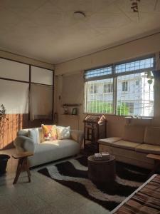 a living room with a couch and a table at Pachamec House in Guayaquil