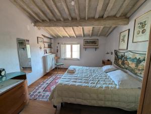 a bedroom with a large bed and a wooden ceiling at da Francesco rooms in Lucca