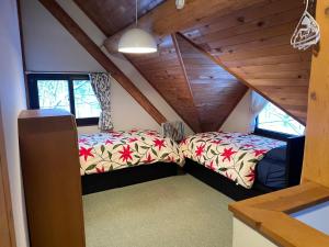 two beds in the attic of a house at Appi Ski Chalet in Hachimantai