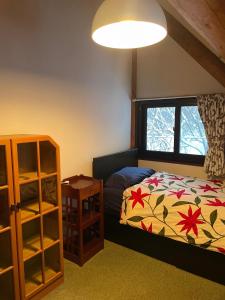 a bedroom with a bed and a window at Appi Ski Chalet in Hachimantai