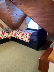 a bedroom with a bed in a attic at Appi Ski Chalet in Hachimantai
