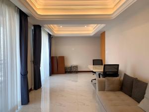 a living room with a couch and a table at Modern Condo in Phnom Penh ByDN in Phnom Penh