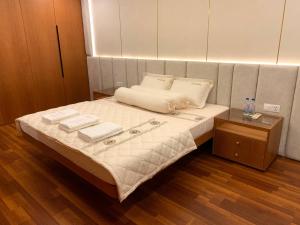 a bedroom with a bed with two towels on it at Modern Condo in Phnom Penh ByDN in Phnom Penh