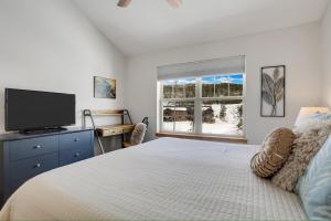 a bedroom with a bed with a tv and a window at Majestic Views - Steps to the Trails in Fraser