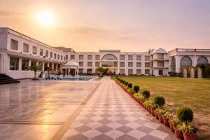 a view of a building with a lawn at Orchha River Stone Resort in Orchha