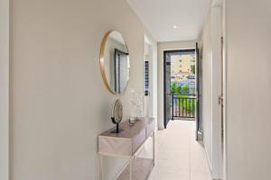 a hallway with a mirror and a dresser in a room at Luxury Two-Bedroom Apartments at Blue Bay The Breeze in Dorp Sint Michiel