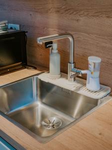 a kitchen sink with a soap dispenser next to it at Up and above in Kobarid +49 photos