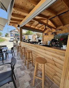 an outdoor bar with stools and a counter at Vila Kylie in Ksamil