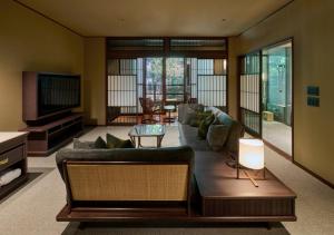 a living room with a couch and a television at Fufu Atami in Atami