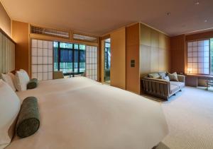 a large bedroom with a large bed and a couch at Fufu Atami in Atami +26 photos
