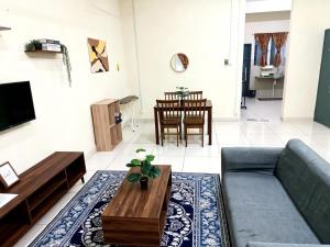 a living room with a couch and a table at SuaTamu Homestay One Aircond in Kamunting