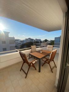 a table and chairs on a balcony with a view at The Costa Suite byArtistunknown in Vari