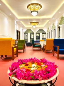 a lobby with a large arrangement of flowers on the floor at Hotel Khumbila in Kathmandu