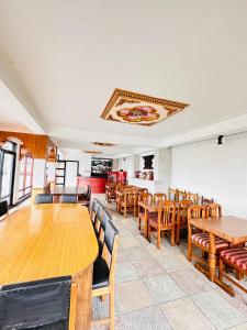 a dining room with wooden tables and chairs at Hotel Khumbila in Kathmandu
