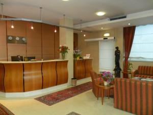 a lobby with a reception desk and a waiting room at Hotel Riviera in Segrate