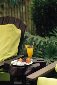 a plate of food and a drink on a table at Trang An Ninh Binh Rustic Hideaway in Ninh Binh