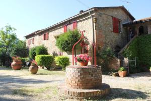 a brick building with potted plants in front of it at Agriturismo La Selva in Siena