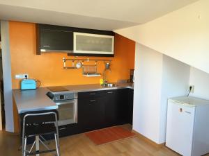 a kitchen with a sink and a stove and a refrigerator at Apartament Cal Jalmar in Solsona