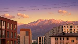 a view of a city with mountains in the background at Cozy Almaty Escape in Almaty