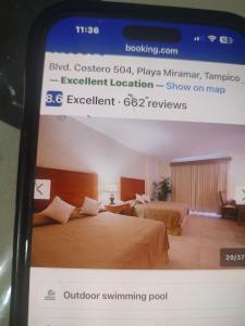 a cell phone screenshot of a hotel room with two beds at Arenas del mar in Monterrey