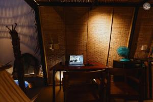a room with a table with a laptop on it at mango house, hide out Can Tho in Ấp Bình Thương