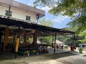 a building with a lot of tables and chairs at Green Gen Hotel Phuket in Phuket