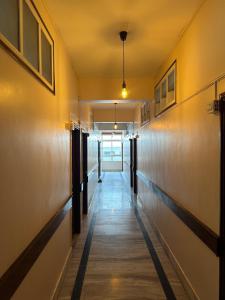 a corridor of an office building with a long hallway at Hotel Sanman in Gulbarga