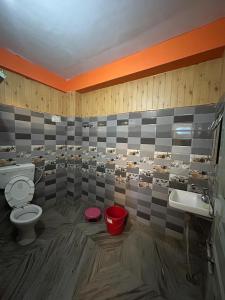 a bathroom with a toilet and a sink at Hotel Ganpati in Lohaghāt +28 photos
