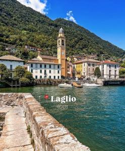 a town with a clock tower on a body of water at Appartamento Ebhouse in Capiago Intimiano